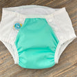 4-in-1 big kid cloth diaper with front snaps. Works as a diaper cover, swim diaper, training pant, and cloth diaper - for big kids with disabilities and special needs