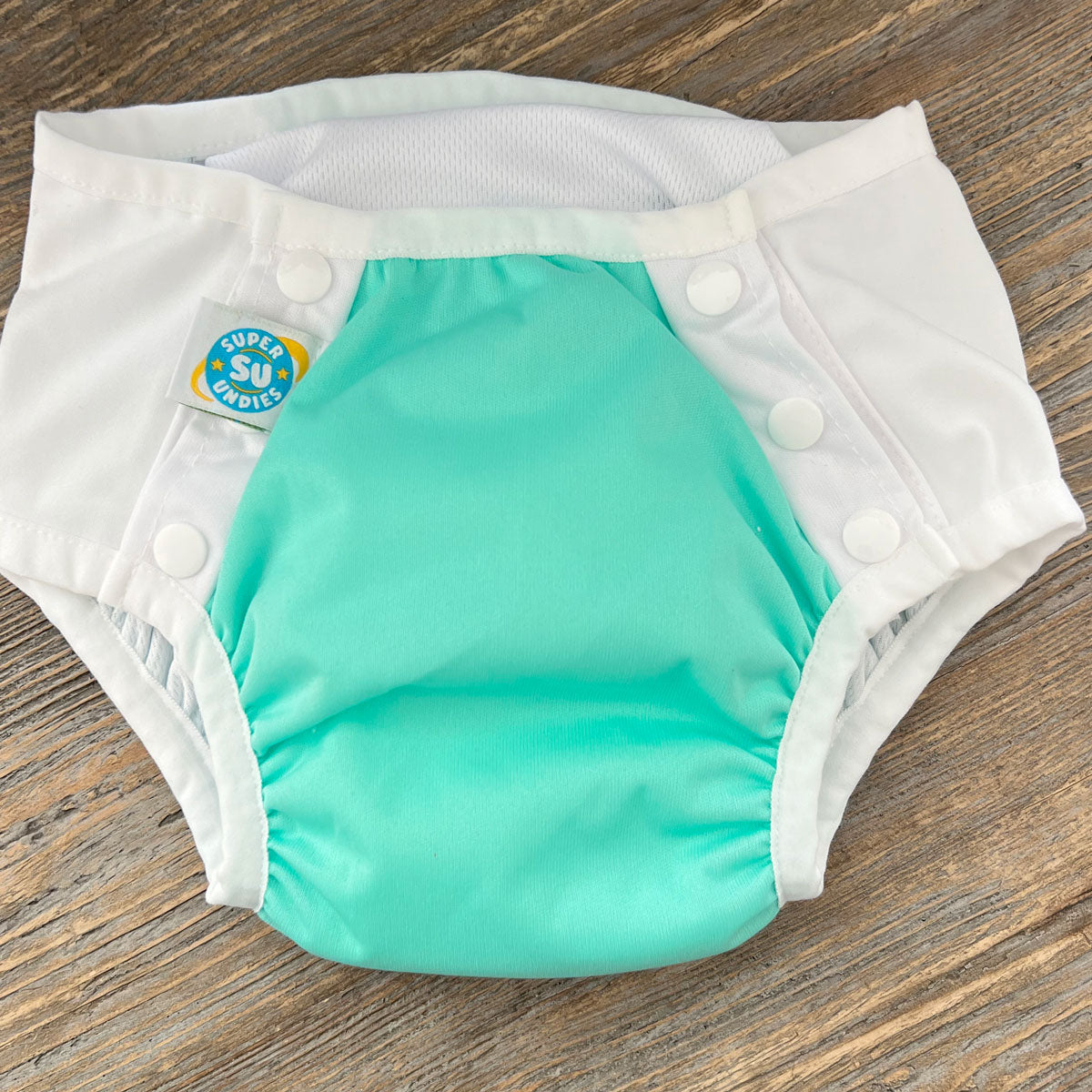 4-in-1 big kid cloth diaper with front snaps. Works as a diaper cover, swim diaper, training pant, and cloth diaper - for big kids with disabilities and special needs