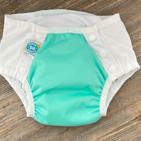 4-in-1 big kid cloth diaper with front snaps. Works as a diaper cover, swim diaper, training pant, and cloth diaper - for big kids with disabilities and special needs